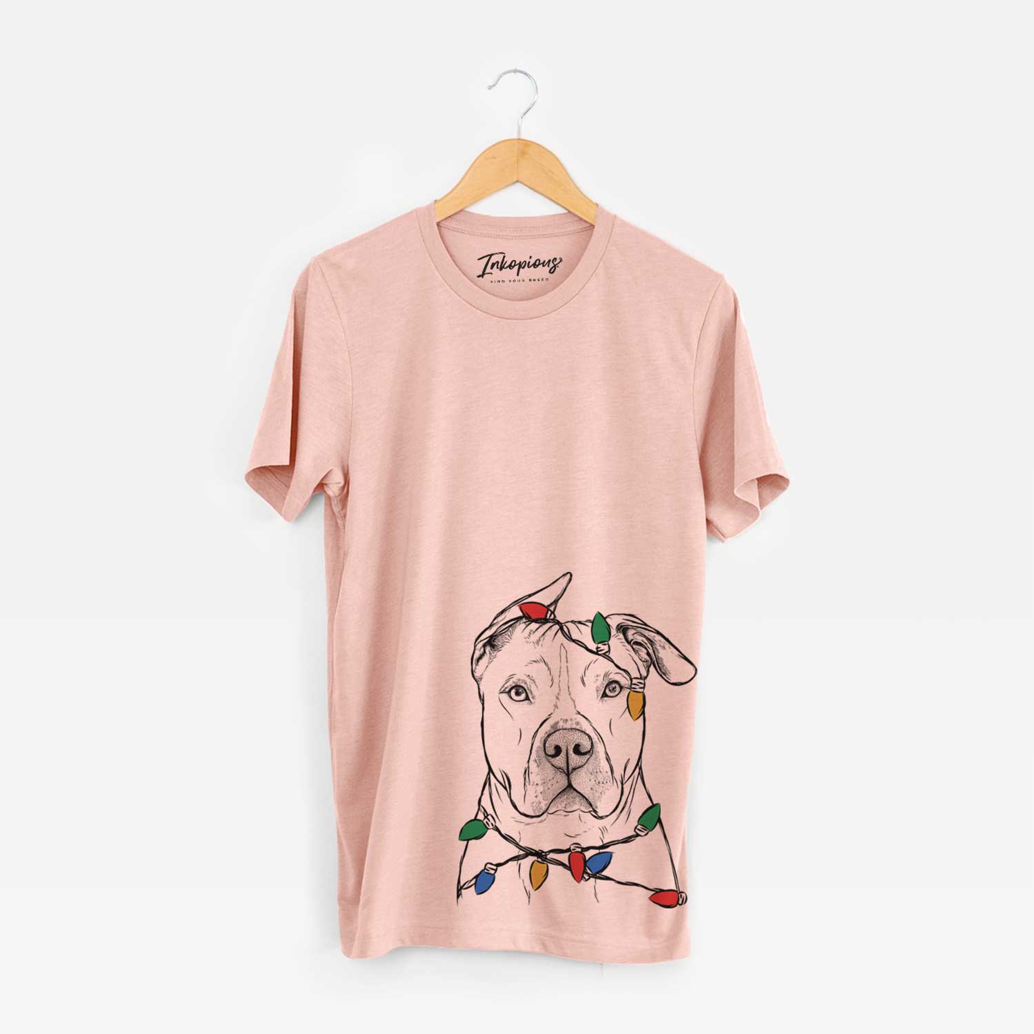 Hand-drawn sketch of Teddy Jam the Pitbull wrapped in Christmas lights on a Peach Unisex crewneck