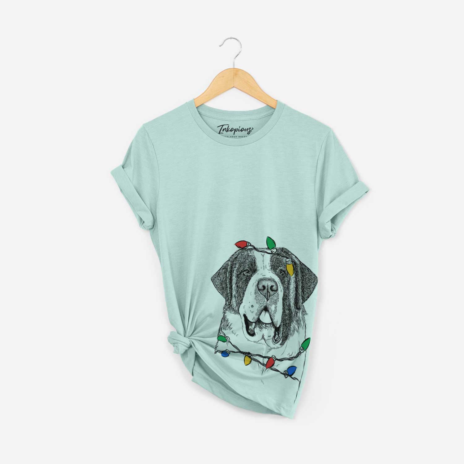 Hand-drawn sketch of Thor the Saint Bernard wrapped in Christmas lights on a Heather Sage Unisex crewneck