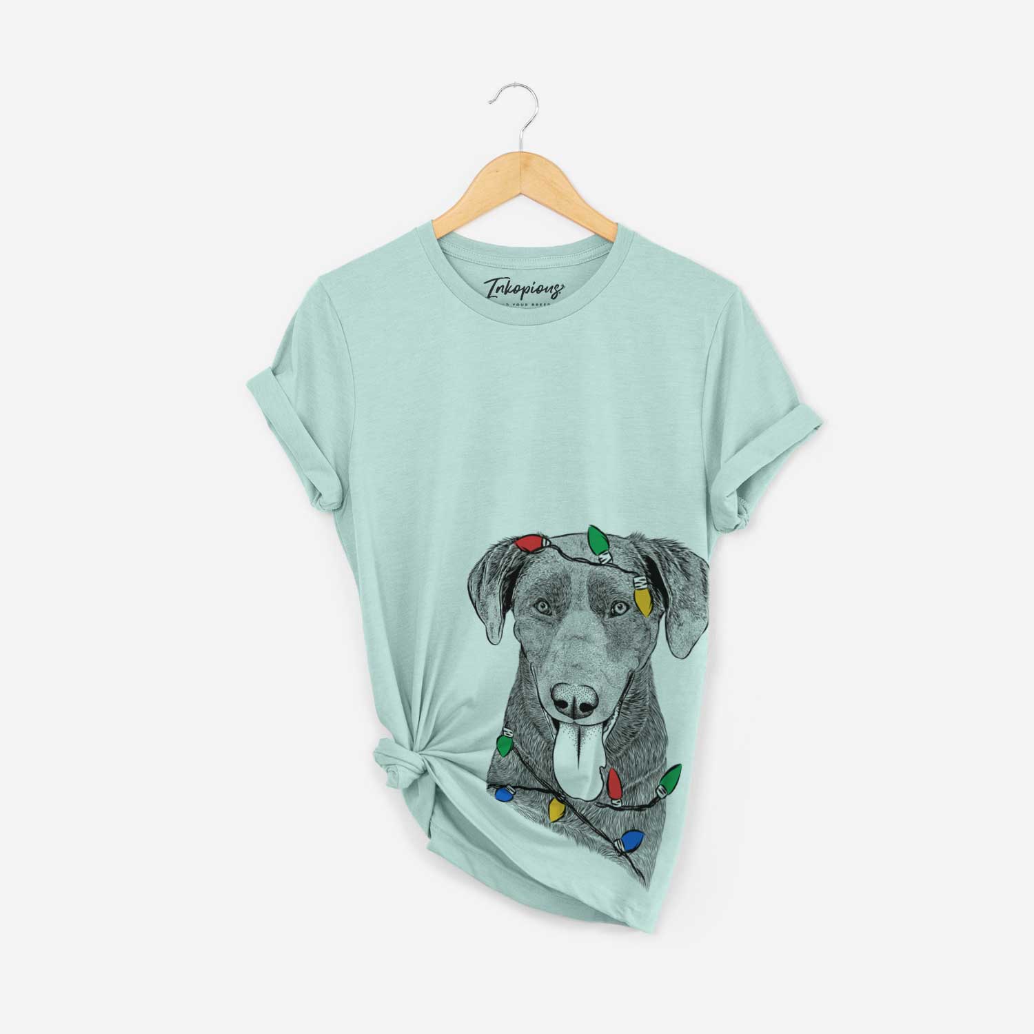 Hand-drawn sketch of Tobes the Chocolate Lab wrapped in Christmas lights on a Heather Sage Unisex crewneck
