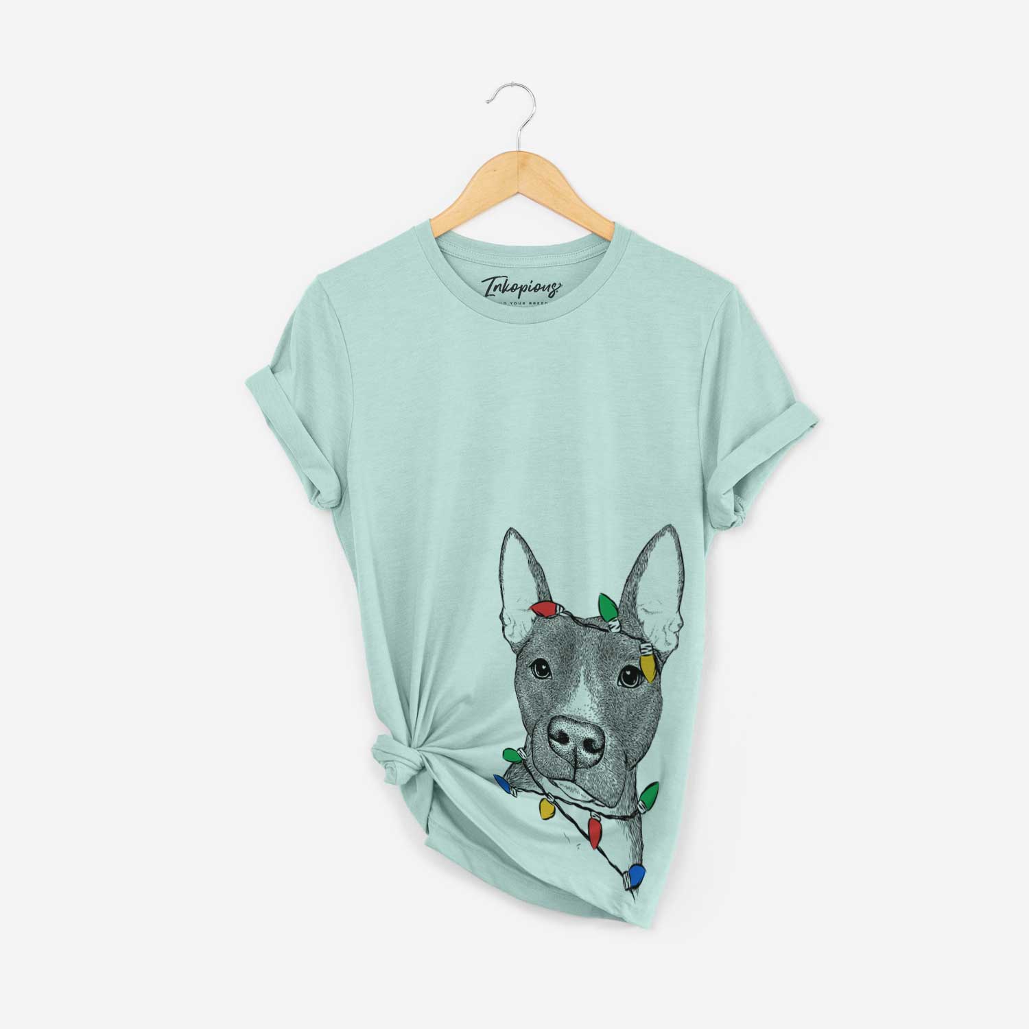 Hand-drawn sketch of Violet the Pitbull wrapped in Christmas lights on a Heather Sage Unisex crewneck