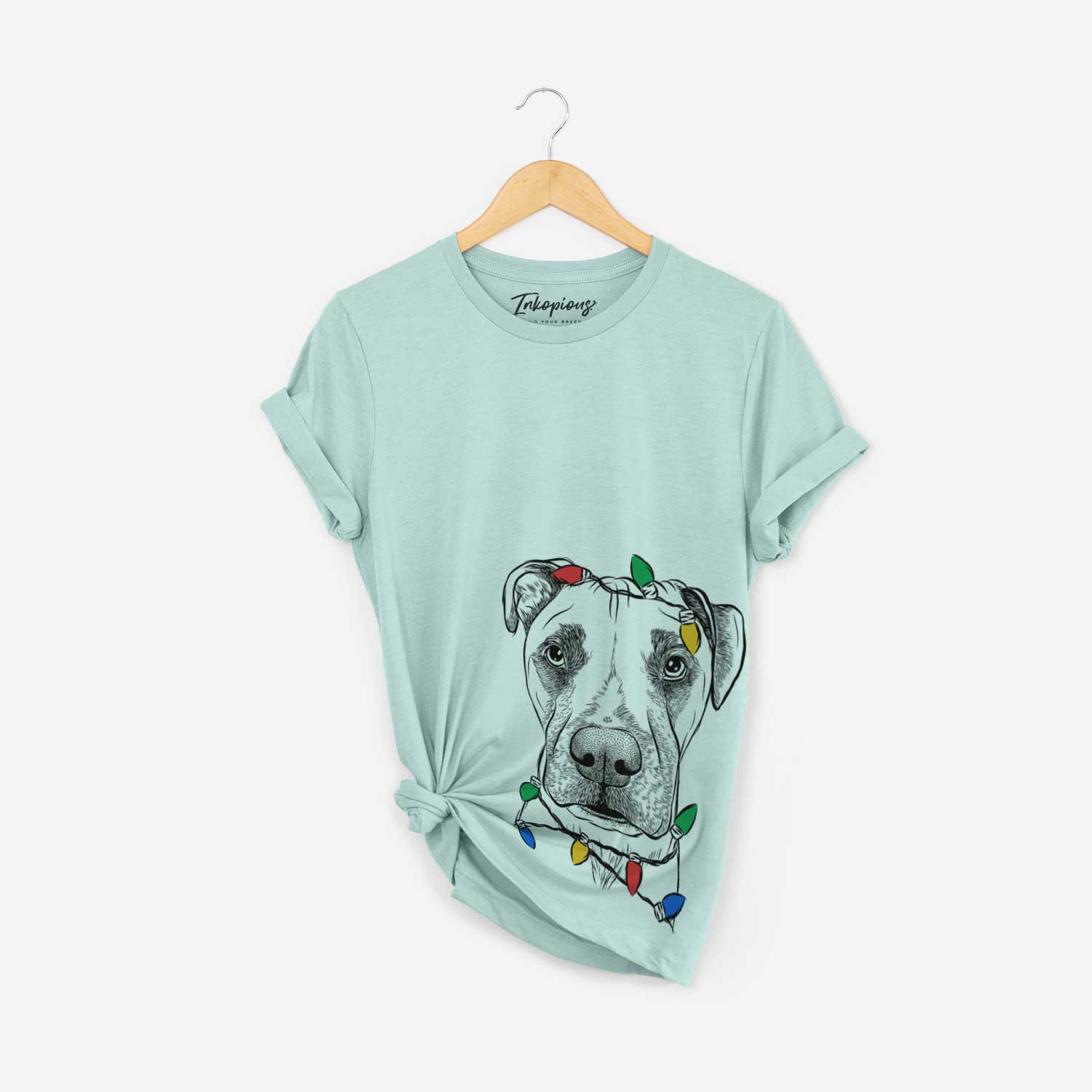 Hand-drawn sketch of Waylon the Boxane wrapped in Christmas lights on a Heather Sage Unisex crewneck