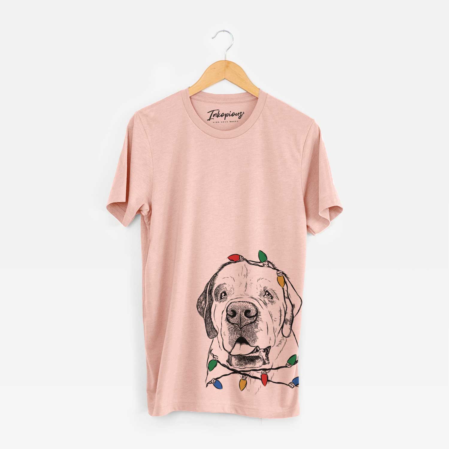 Hand-drawn sketch of Wendy the Saint Bernard wrapped in Christmas lights on a Peach Unisex crewneck