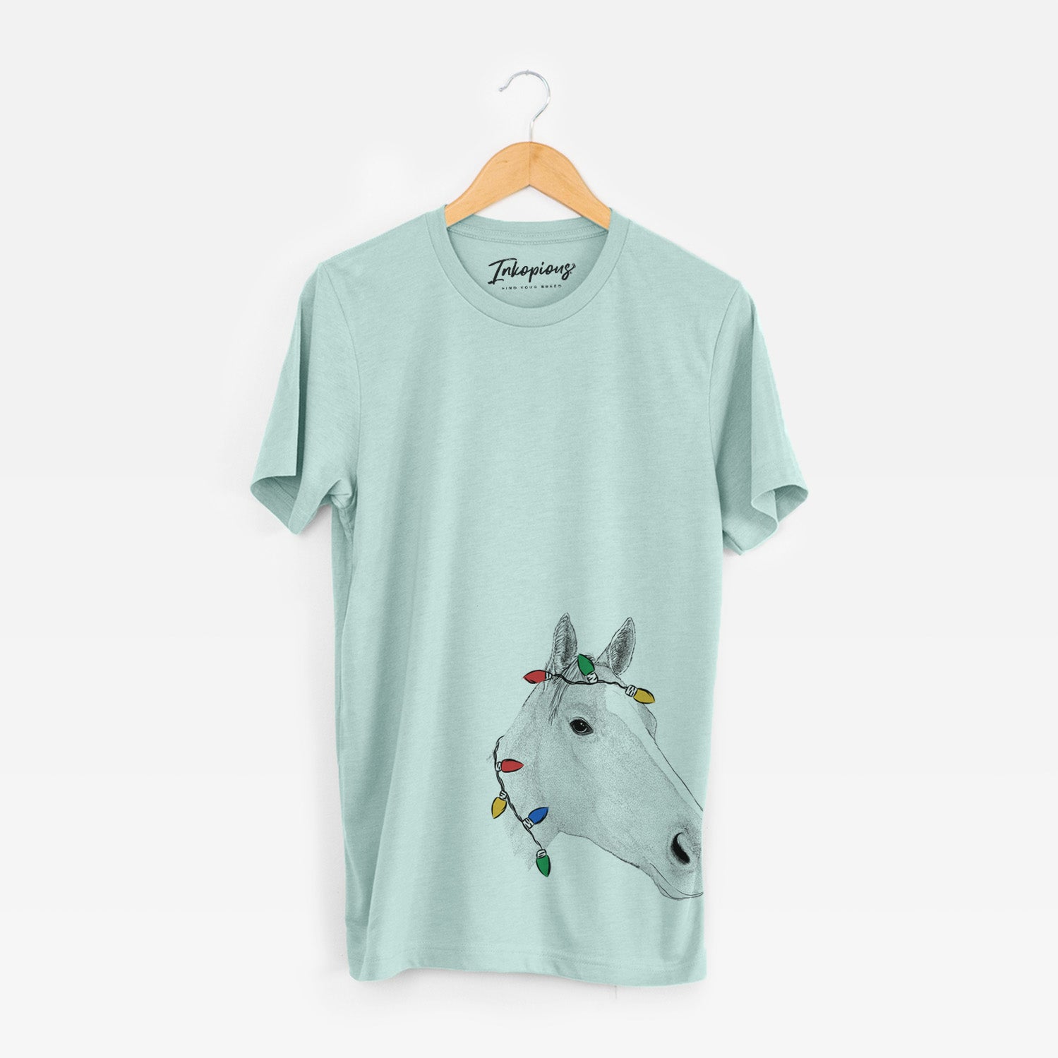 Hand-drawn sketch of Westley the Horse wrapped in Christmas lights on a Heather Sage Unisex crewneck