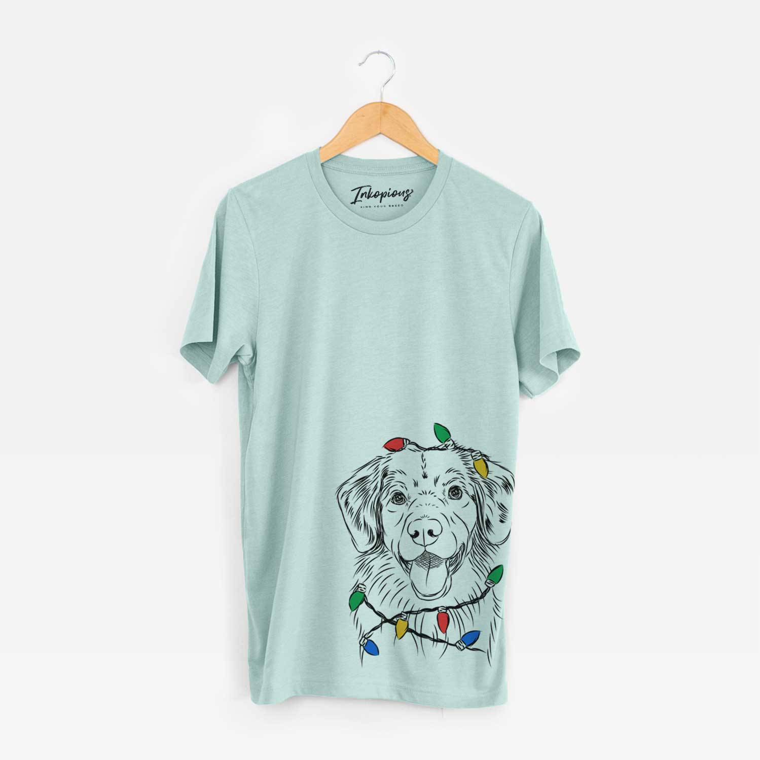Hand-drawn sketch of Weston the Nova Scotia Duck Tolling Retriever wrapped in Christmas lights on a Heather Sage Unisex crewneck