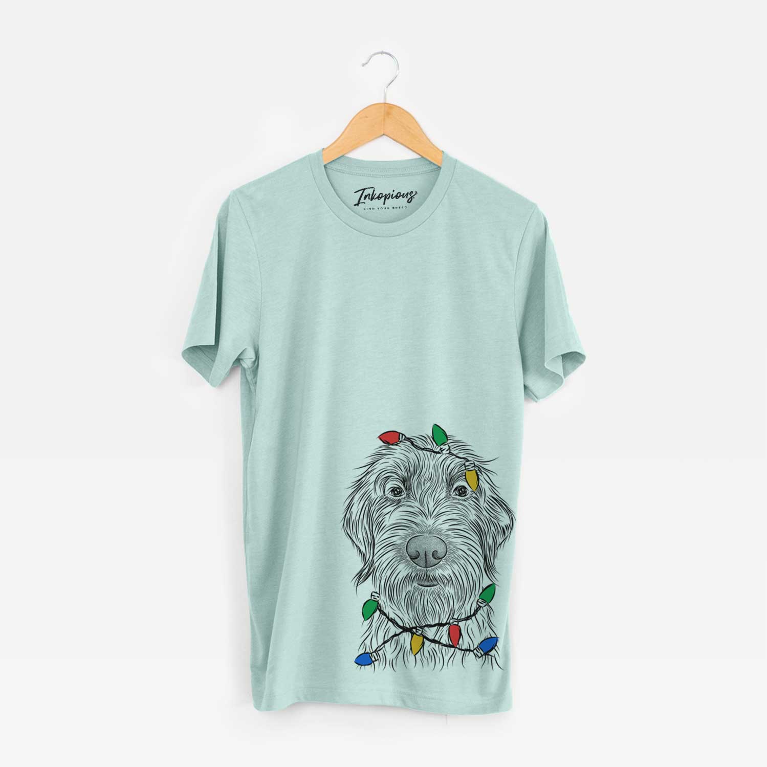 Hand-drawn sketch of Wilkins the Wirehaired Pointing Griffon wrapped in Christmas lights on a Heather Sage Unisex crewneck