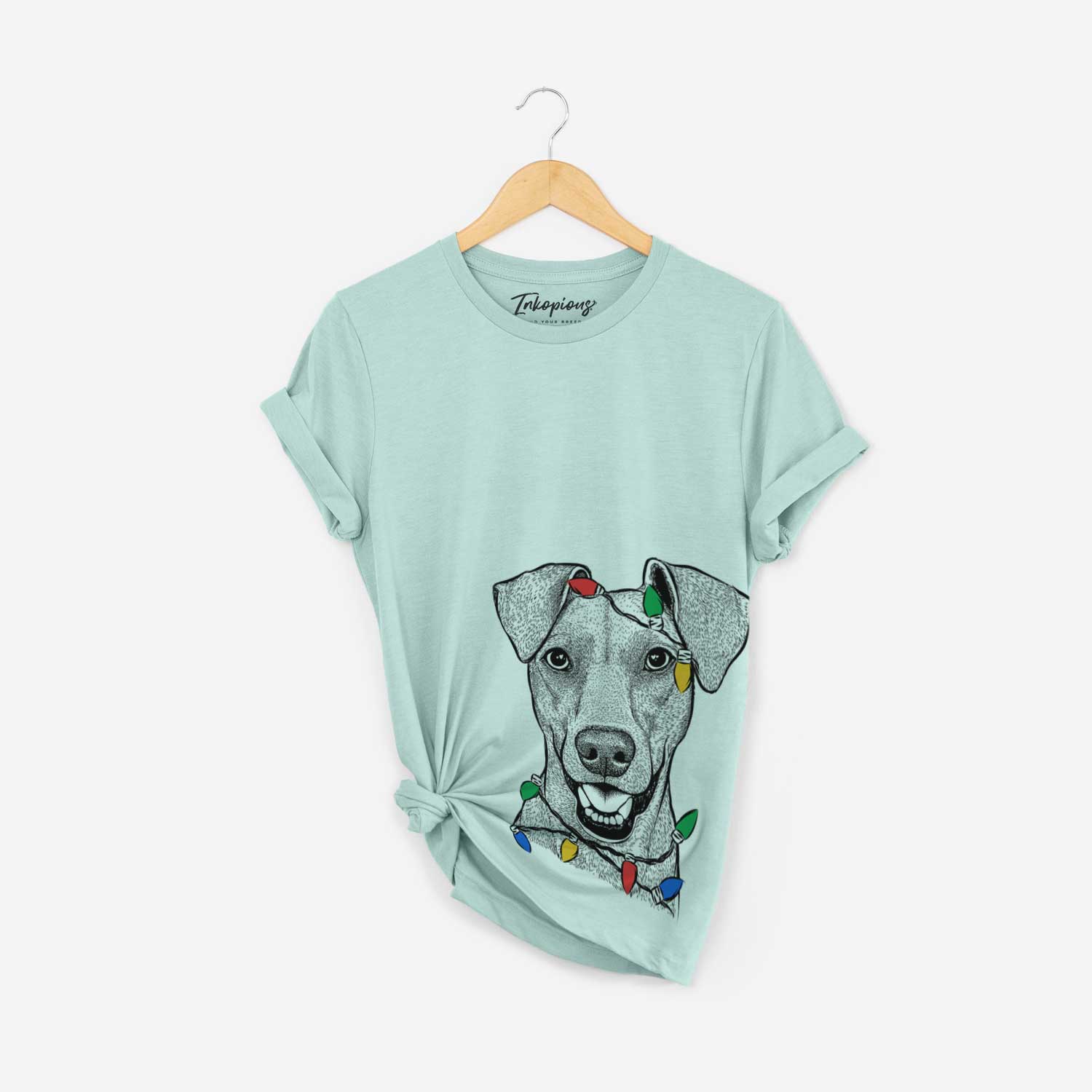 Hand-drawn sketch of Willow the German Pinscher wrapped in Christmas lights on a Heather Sage Unisex crewneck