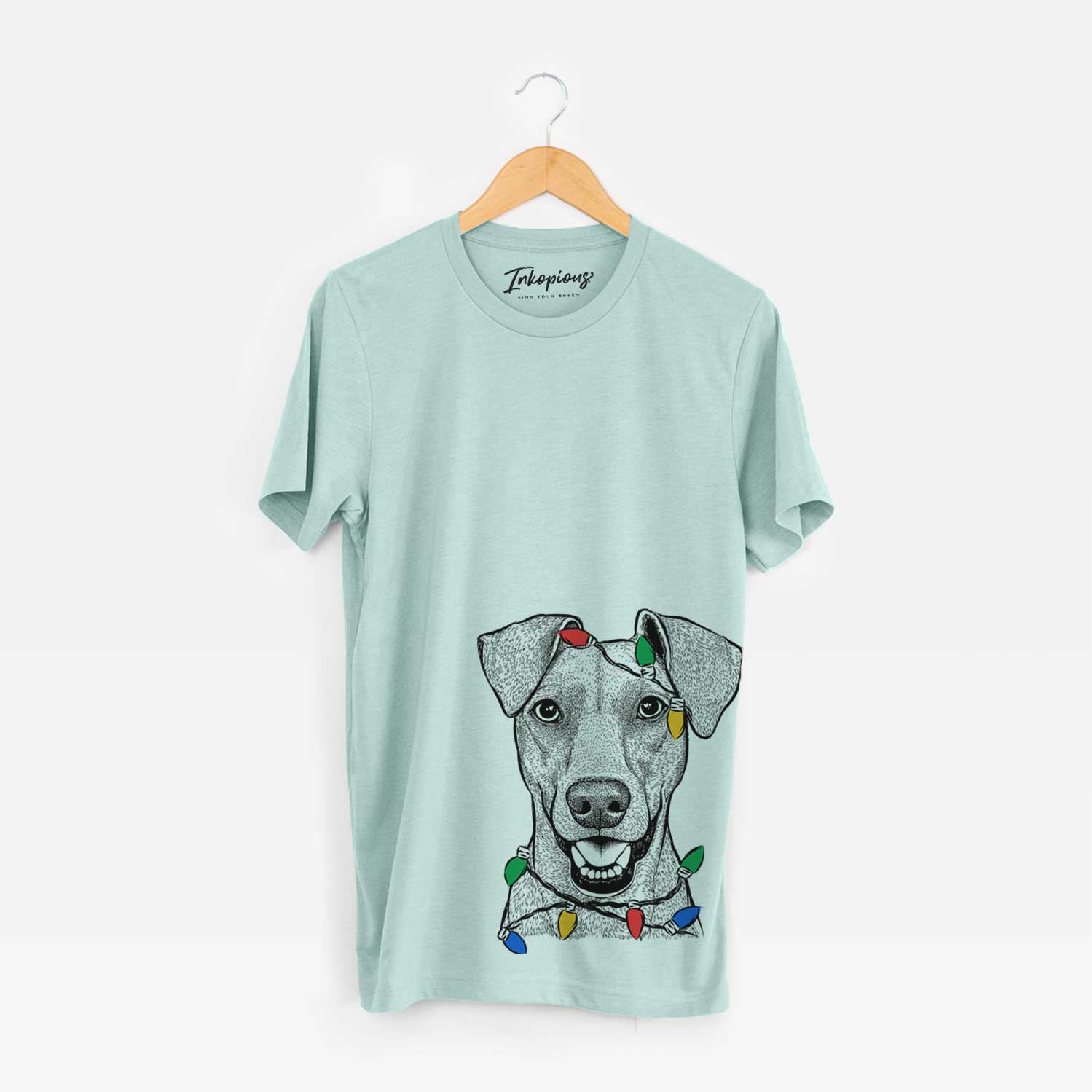 Hand-drawn sketch of Willow the German Pinscher wrapped in Christmas lights on a Heather Sage Unisex crewneck