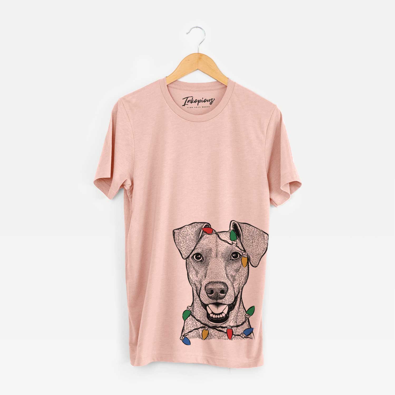 Hand-drawn sketch of Willow the German Pinscher wrapped in Christmas lights on a Peach Unisex crewneck