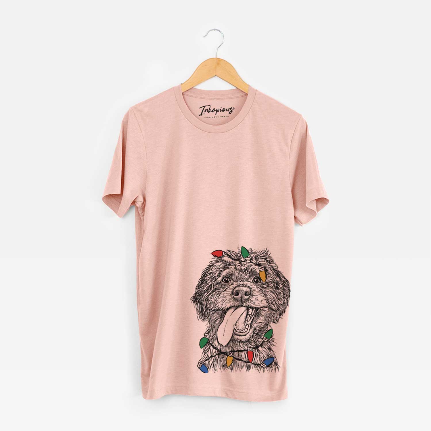 Hand-drawn sketch of Winnie the Mini Aussiedoodle wrapped in Christmas lights on a Peach Unisex crewneck