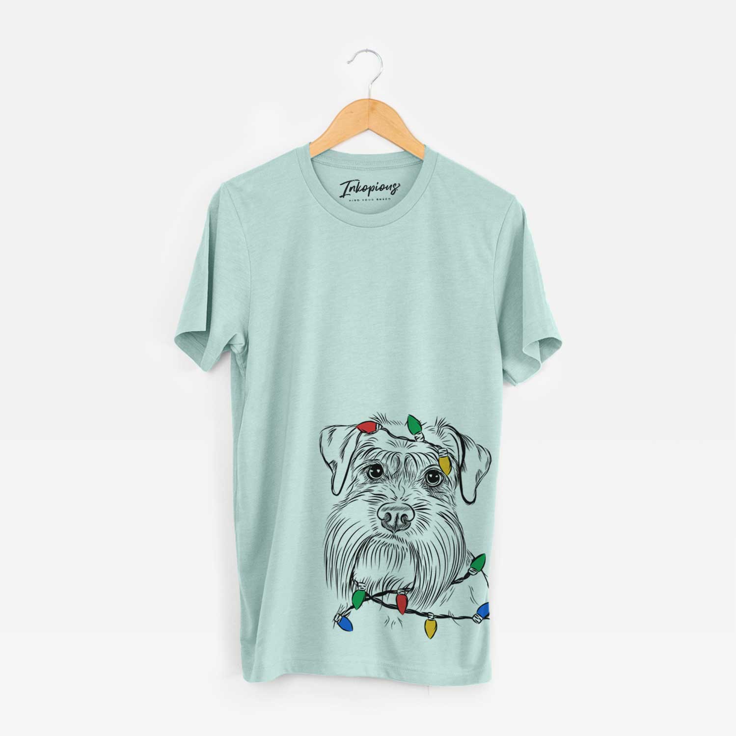 Hand-drawn sketch of Wrigley the Schnauzer wrapped in Christmas lights on a Heather Sage Unisex crewneck