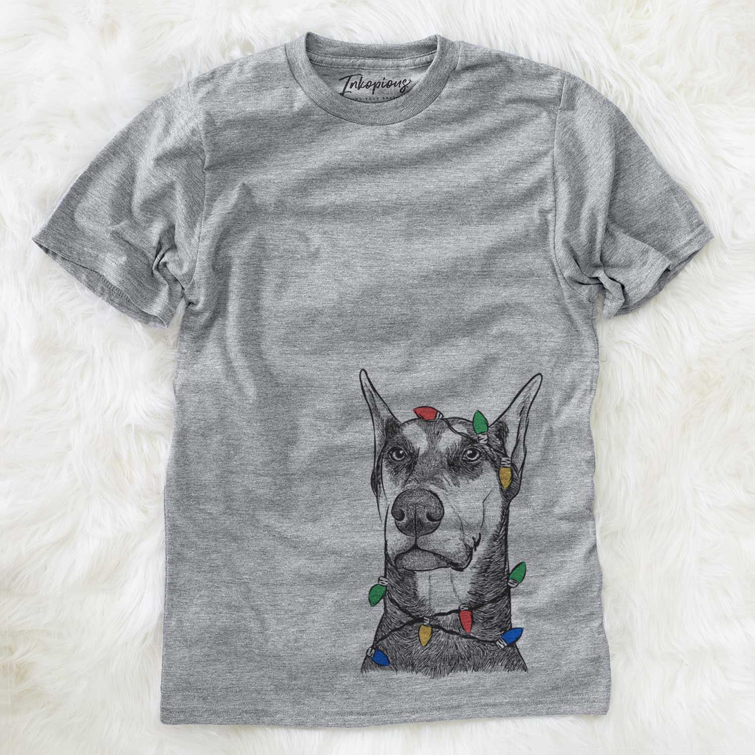 Hand-drawn sketch of Zeus the Doberman Pinscher wrapped in Christmas lights on a Grey Unisex crewneck