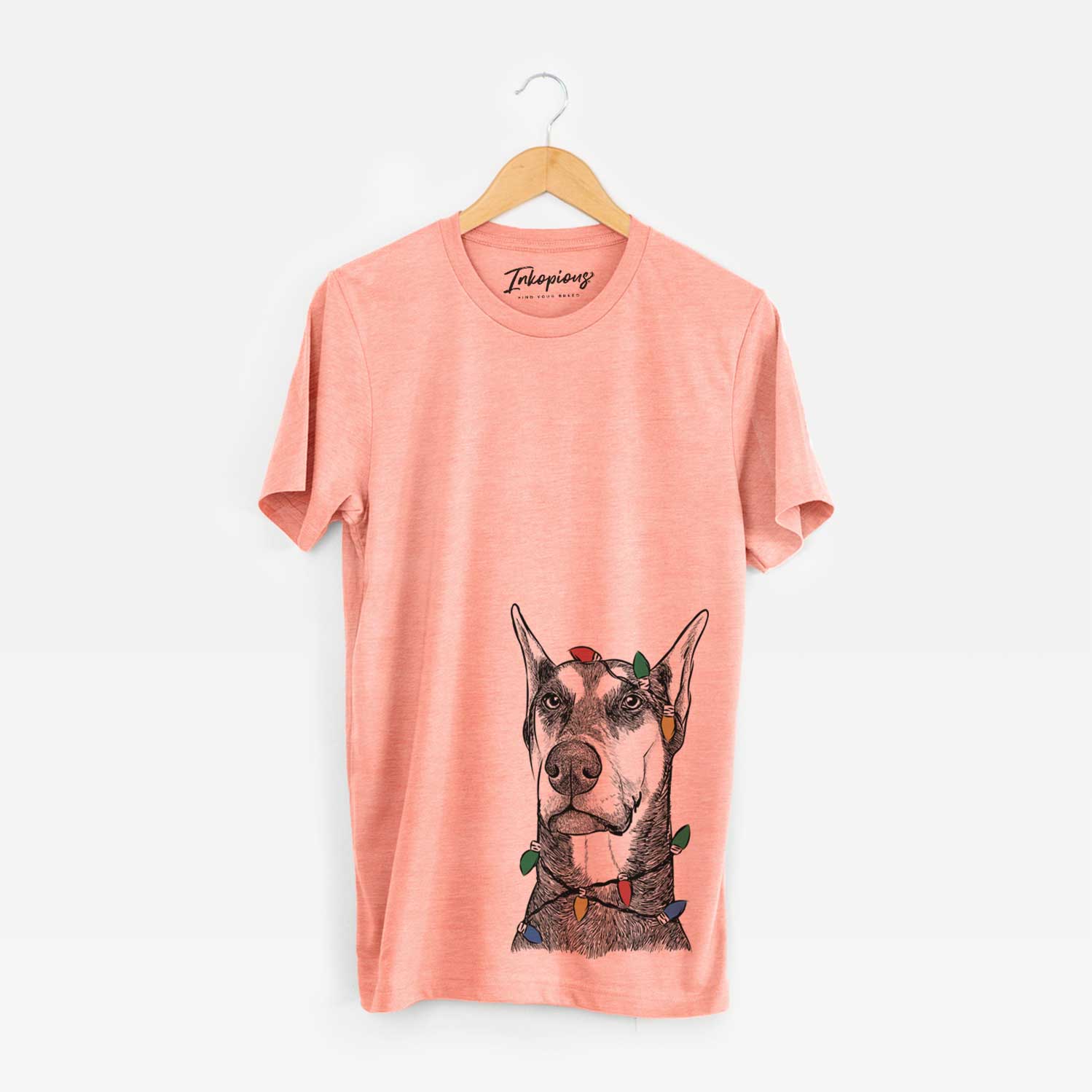 Hand-drawn sketch of Zeus the Doberman Pinscher wrapped in Christmas lights on a Sunset Unisex crewneck