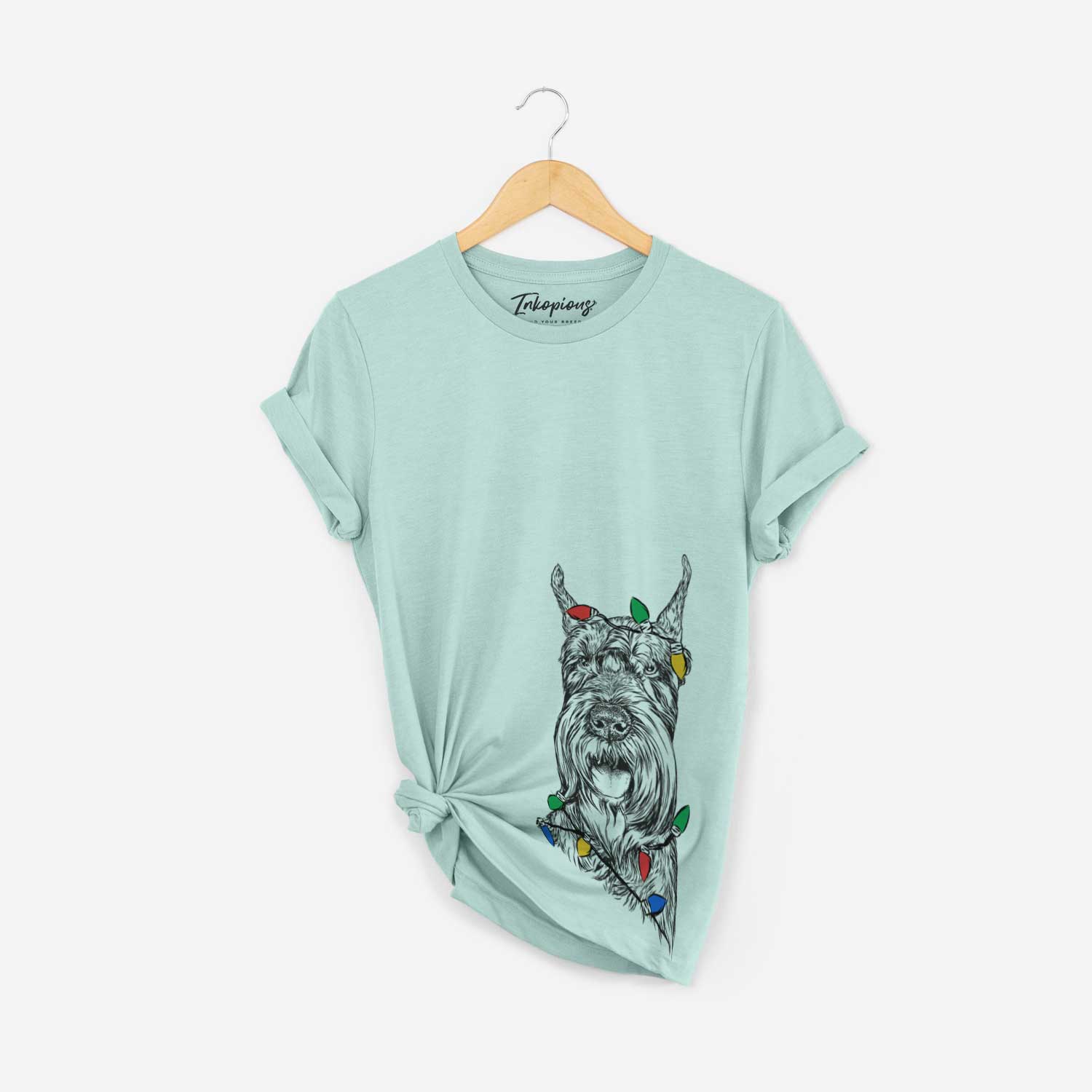 Hand-drawn sketch of Zuri the Giant Schnauzer wrapped in Christmas lights on a Heather Sage Unisex crewneck