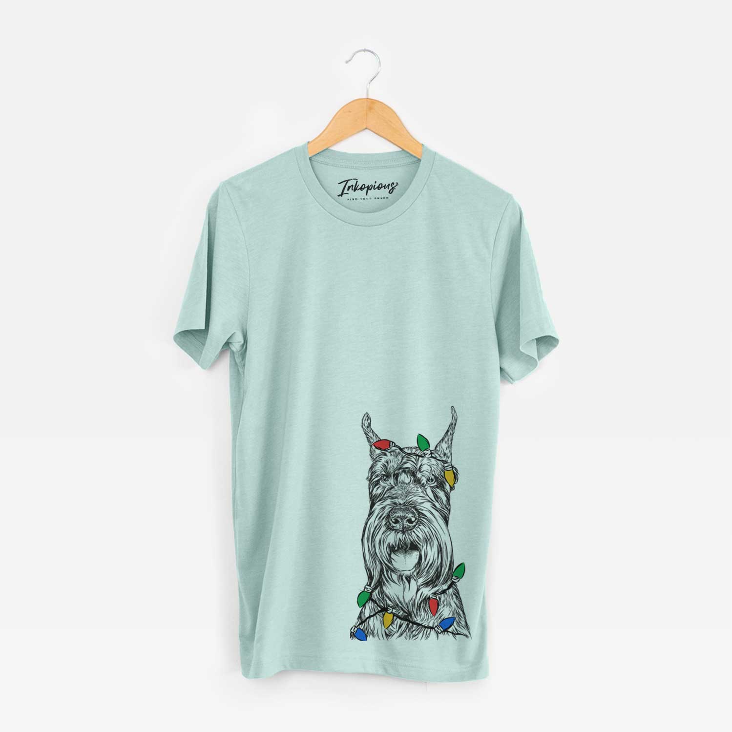 Hand-drawn sketch of Zuri the Giant Schnauzer wrapped in Christmas lights on a Heather Sage Unisex crewneck
