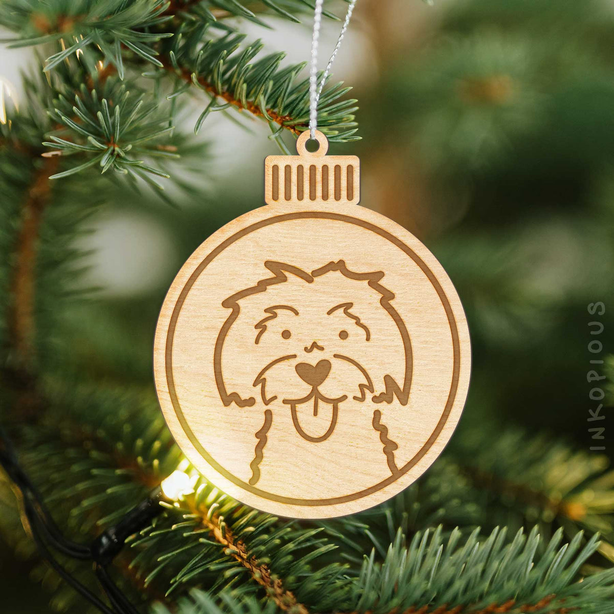 Round Maltese Christmas ornament with a unique Maltese drawing